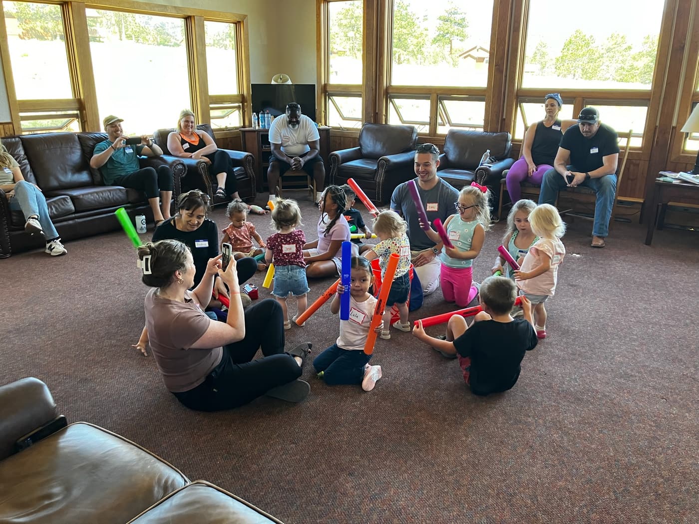 Young campers and family members taking part in a colorful group activity