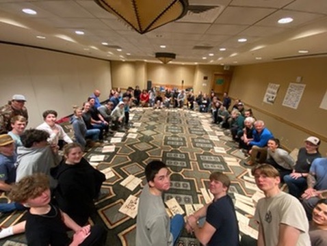 Winter Burn Camp participants gathered together in a large indoor circle